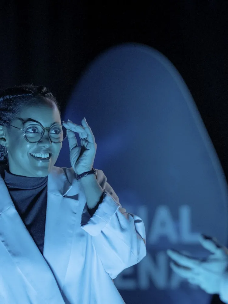 Person in a technology environment with digital projections, representing innovation and smart mobility solutions